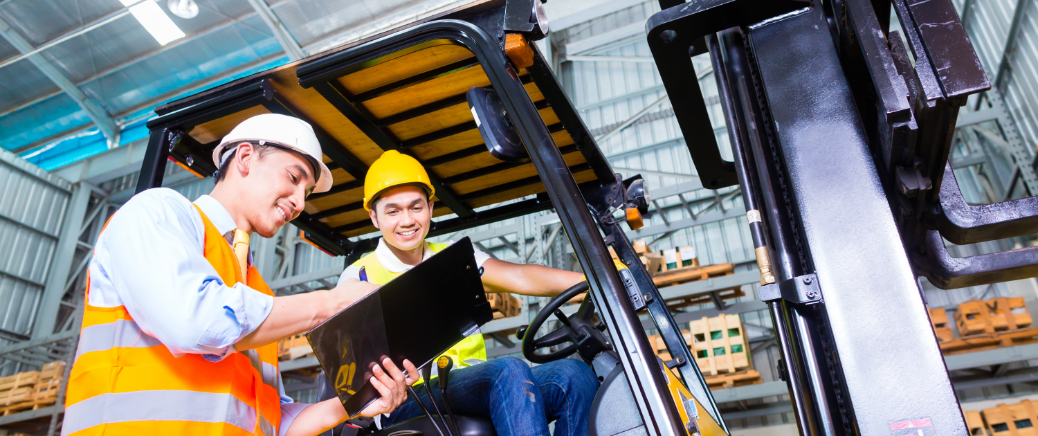 Asian lift truck driver and foreman in storage